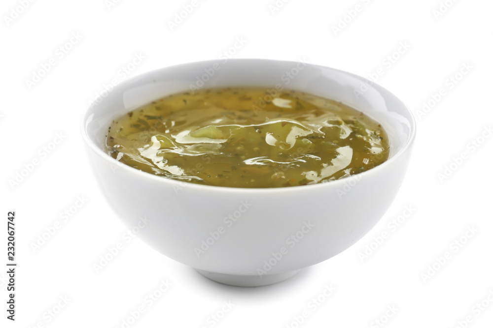 Tasty green sauce in bowl on white background Tasty green sauce in bowl on white background