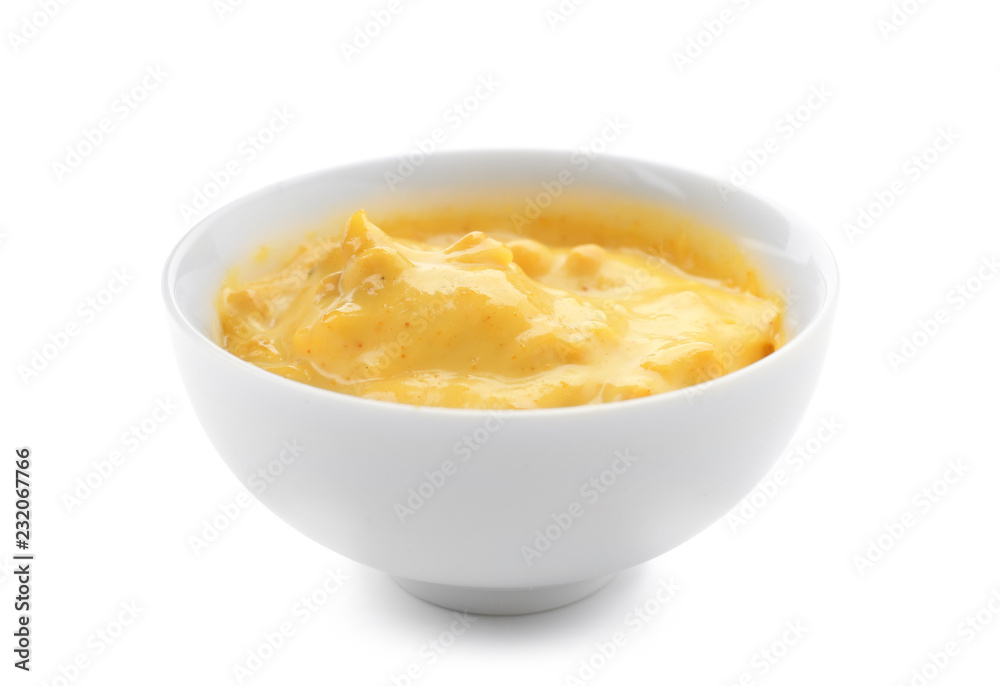 Tasty yellow sauce in bowl on white background Tasty yellow sauce in bowl on white background