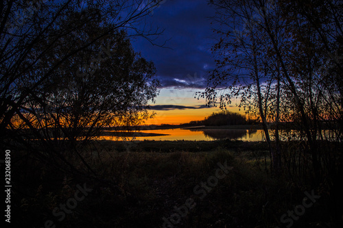 beautiful sunrise on a wild lake in autumn