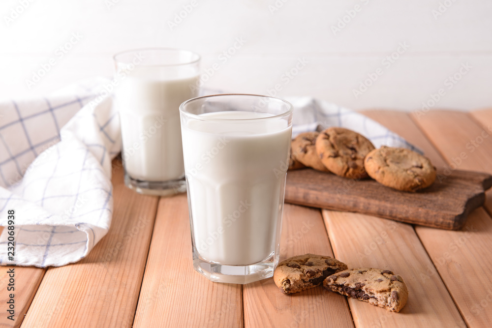 Glasses of tasty milk and cookies on wooden table Glasses of tasty milk and cookies on wooden table