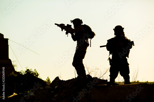 Black silhouettes of pair of soldiers