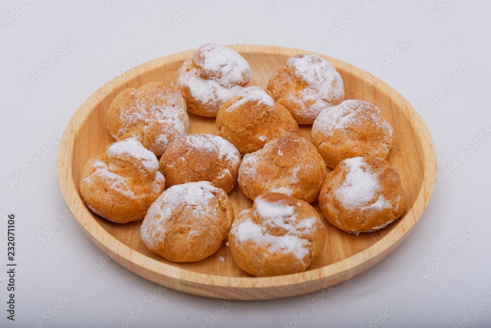 Fried cakes on a wooden plate