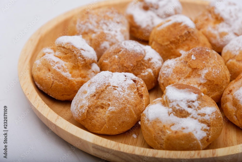 Fried cakes on a wooden plate