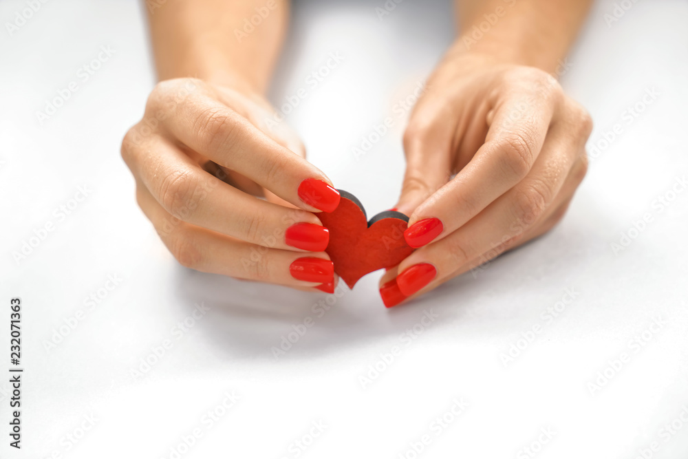 Woman holding heart on white background, closeup