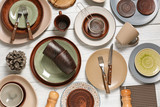 Different tableware and cutlery on wooden table