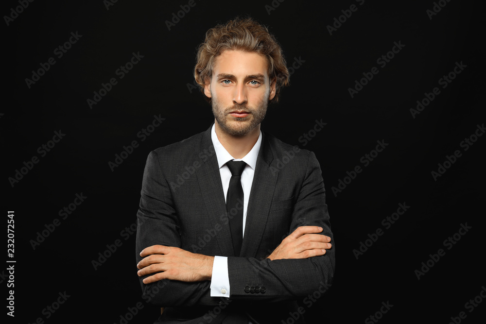 Successful businessman with crossed arms on black background Successful businessman with crossed arms on black background