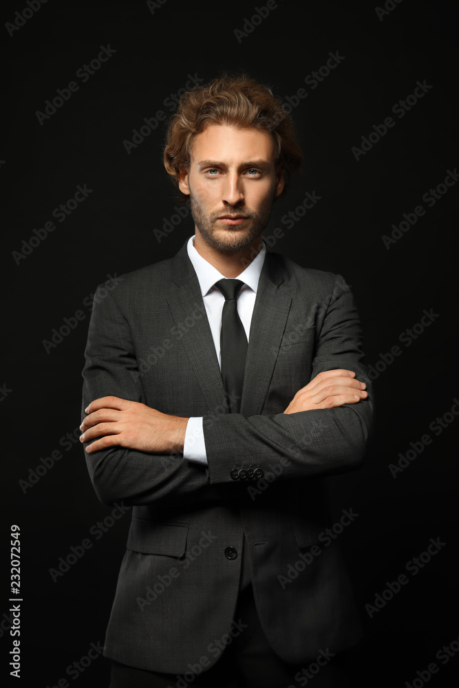 Successful businessman with crossed arms on black background Successful businessman with crossed arms on black background