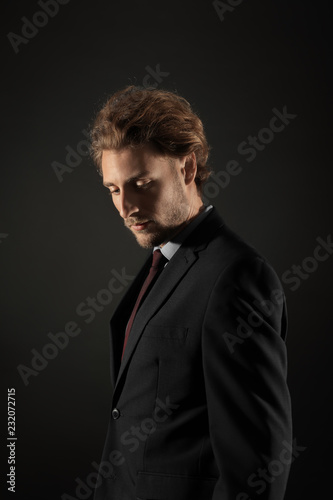 Portrait of handsome businessman on black background