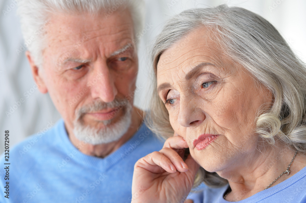 Portrait of cute sad senior couple posing at home Portrait of cute sad senior couple posing at home