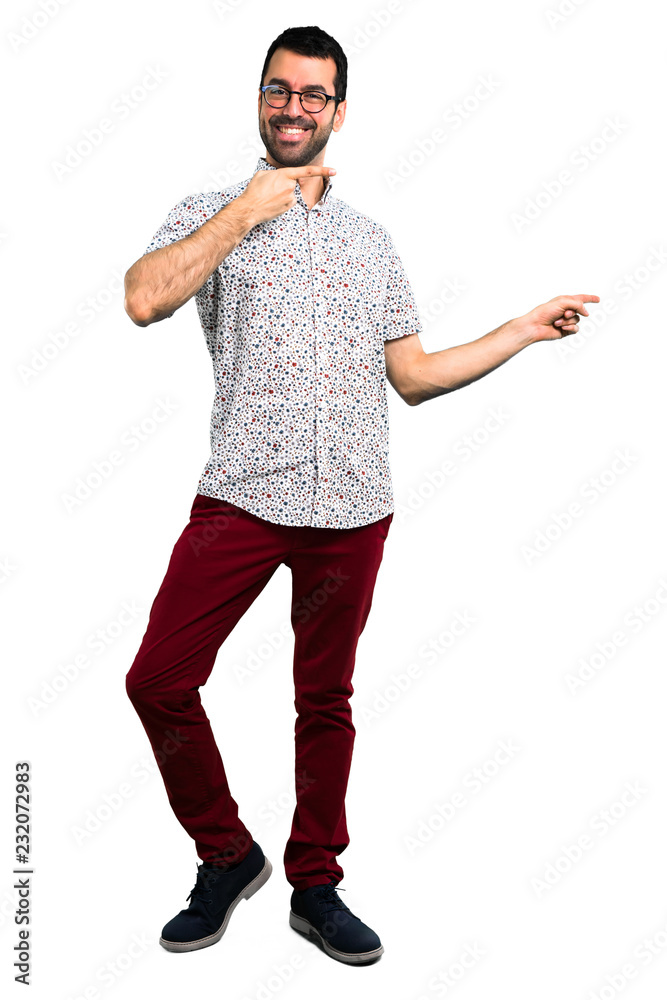 Handsome man with glasses pointing finger to the side and presenting a product Handsome man with glasses pointing finger to the side and presenting a product