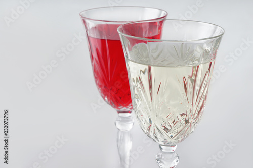 Glasses of different wine on white background