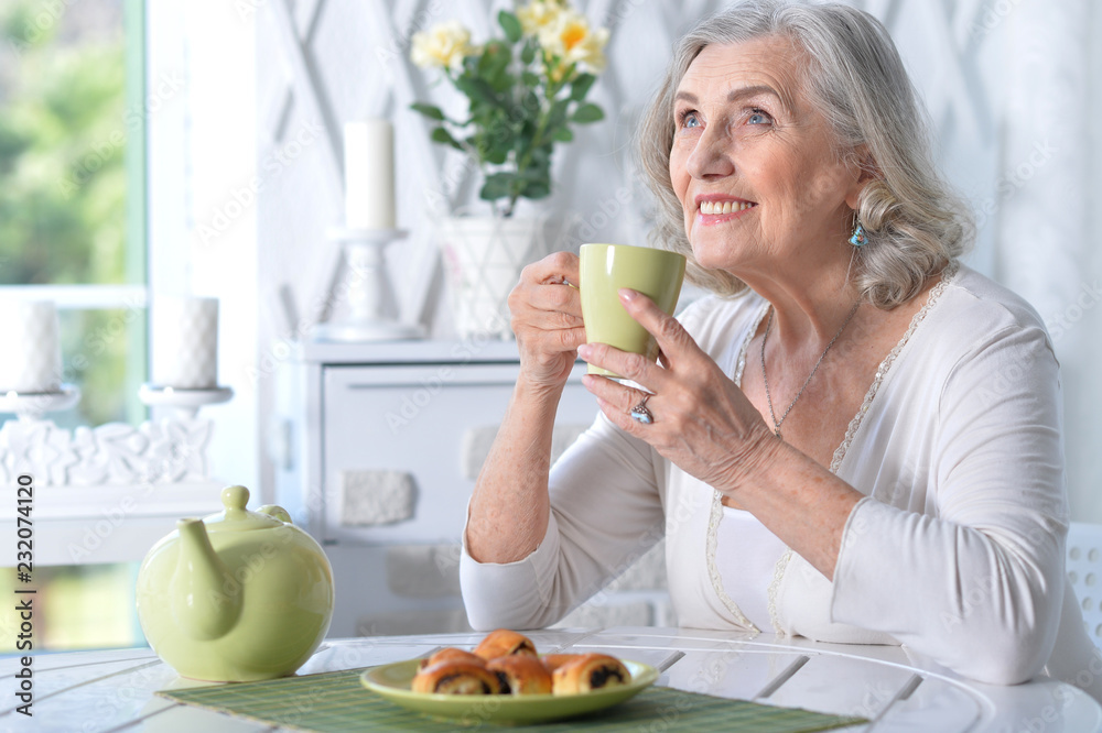 Portrait of cute senior woman having breakfast
