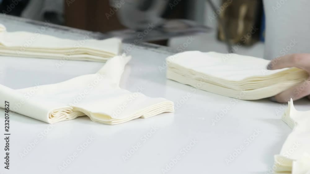 Cutting the fabric, sewing work. Cutting room, cutting light beige cloth tailoring knife. Cutting the fabric, sewing work. Cutting room, cutting light beige cloth tailoring knife.