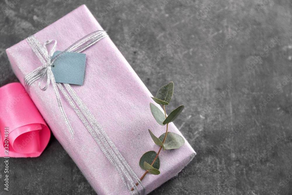 Beautiful gift box on grey table Beautiful gift box on grey table