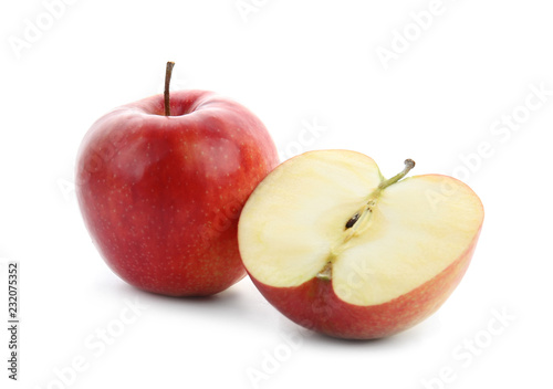 Whole and cut tasty apple on white background