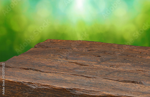 Empty wooden perspective table top on view of green blur background