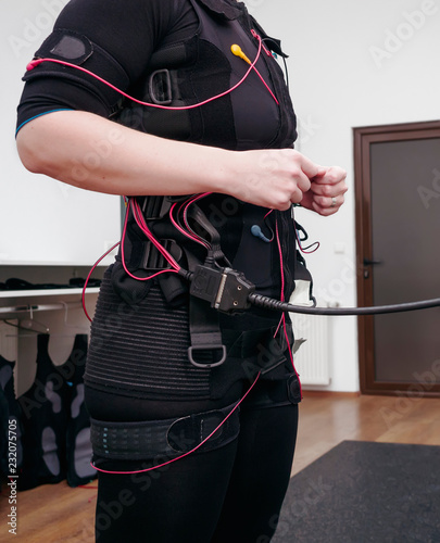 Woman in electro muscular stimulation suit ready for exercises