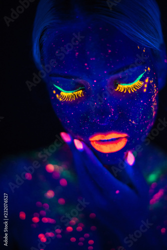 Portrait of Beautiful Fashion Woman in Neon UF Light. Model Girl with Fluorescent Creative Psychedelic MakeUp, Art Design of Female Disco Dancer Model in UV, Colorful Abstract Make-Up