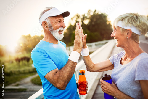 Beautiful mature couple jogging in nature living healthy