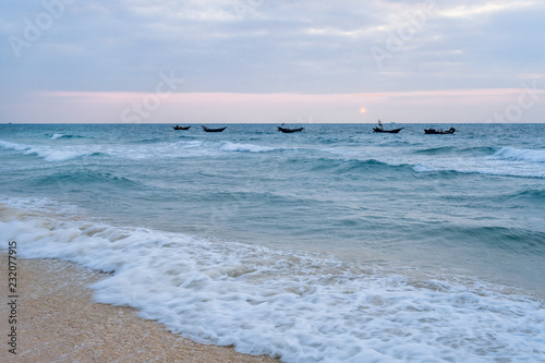 Waving boats in the sea of Weizhou Island, Beihai, Guangxi, China photo