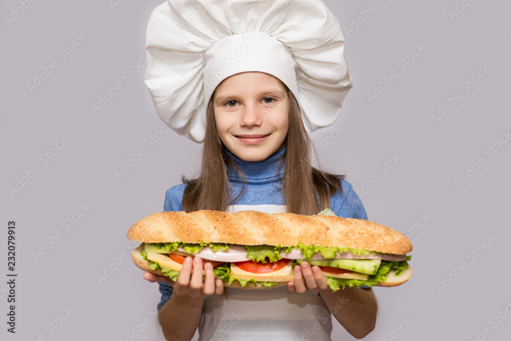 Happy little girl with hot dog and chef uniform isolated on white background Happy little girl with hot dog and chef uniform isolated on white background