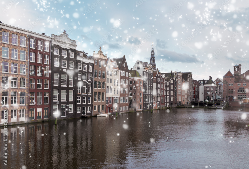 Typical dutch historic houses over canal with snow, Amsterdam, Netherlands