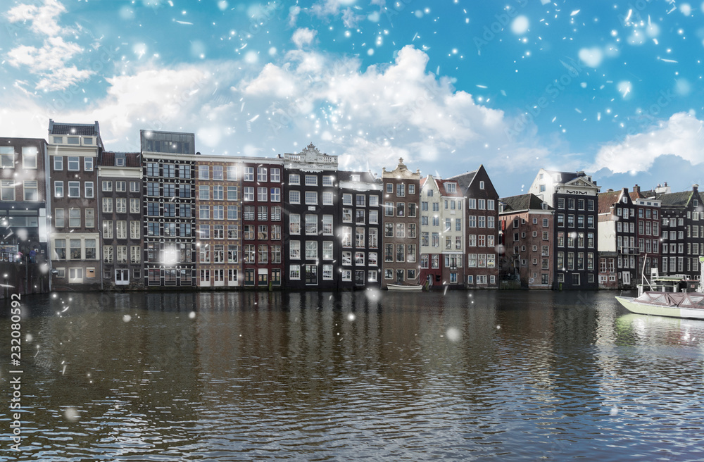 Typical dutch old houses over canal with snow, Amsterdam, Netherlands