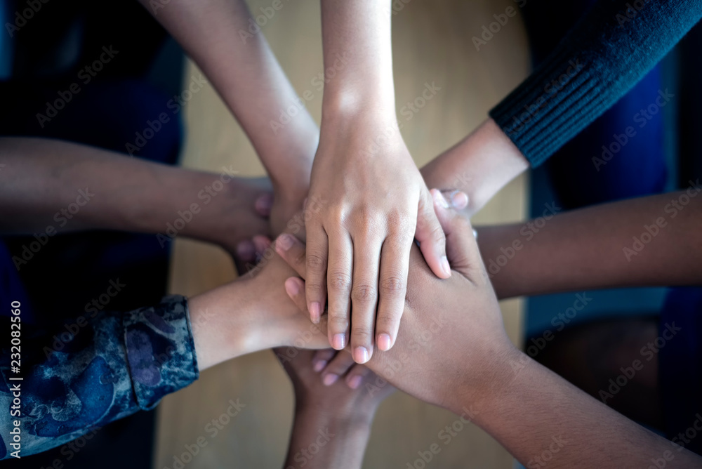Symbolic representation of teamwork by hand coordination, soft focus, vintage tone Symbolic representation of teamwork by hand coordination, soft focus, vintage tone