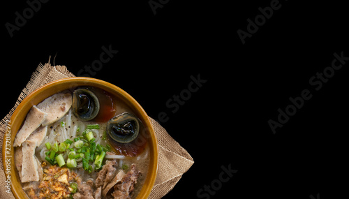 Fototapeta Naklejka Na Ścianę i Meble -  Homemade noodle Vietnam food, Traditional Vietnamese soup on a isolated back, pork noodle rice soup with vegetables, copy space top view