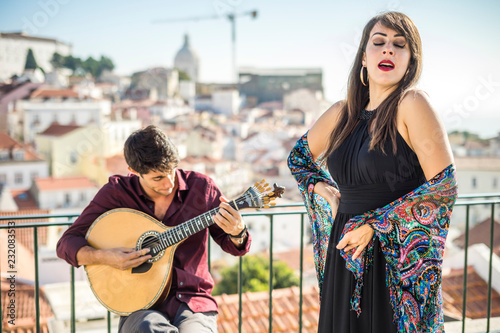 Beautiful fado singer performing with handsome portuguese guitarist player, Portugal photo