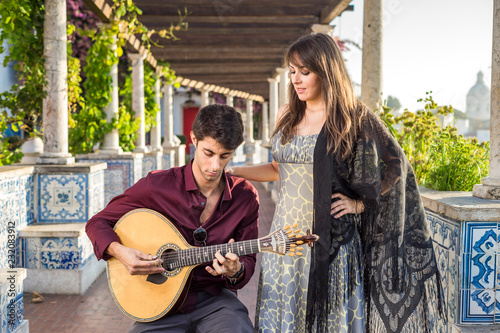 Band performing traditional music fado under pergola with azulejos in Lisbon, Portugal