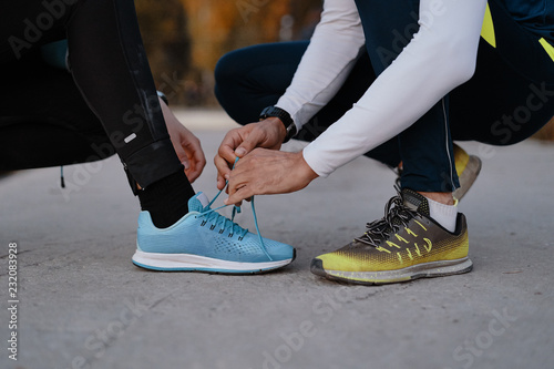 Young couple yying sports shoes.