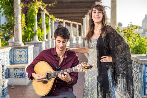 Band performing traditional music fado under pergola with azulejos in Lisbon, Portugal