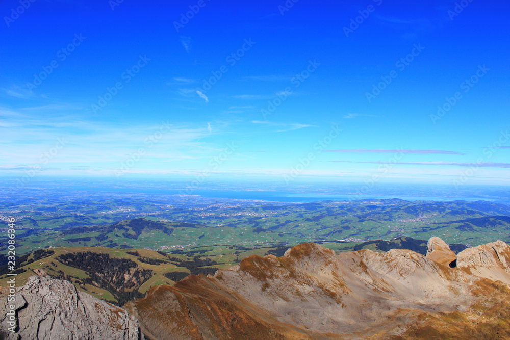 5. Tourism. Leisure. Mountain panorama. View of the adjacent mountain valley with nearby villages on a clear sunny day.