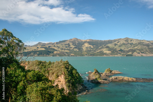 Landscape of ocean, rocks and hills in Banks Peninsula, Christchurch, Canterbury, New Zealand
