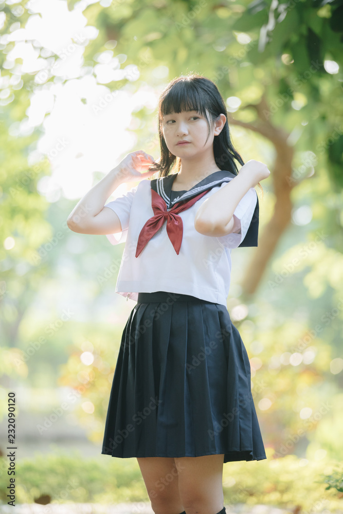 Portrait of asian japanese school girl costume looking at park outdoor film vintage style Portrait of asian japanese school girl costume looking at park outdoor film vintage style