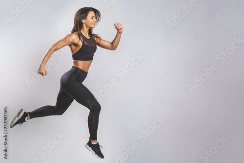 Woman runner in silhouette on white background. Dynamic movement. Side view