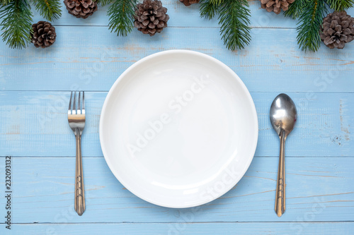 spoon, fork and Empty plate with Christmas decoration, preparation for Happy New Year and Xmas Holidays