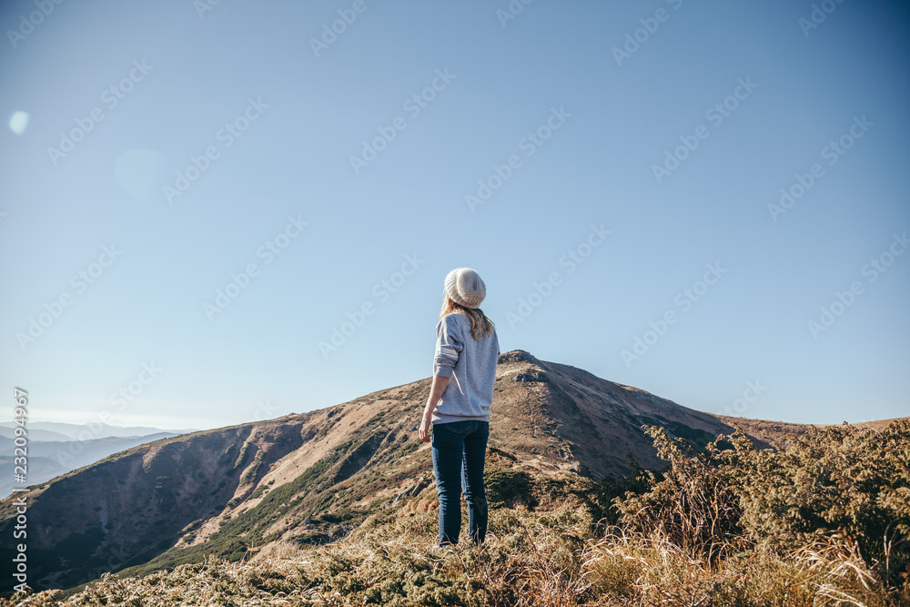 rear view of woman looking at mountains on sunny day, Carpathians, Ukraine rear view of woman looking at mountains on sunny day, Carpathians, Ukraine