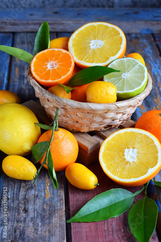 Set of citrus on wooden background: orange, mandarin, lemon, grapefruit, lime, kumquat, tangerine. Fresh organic juicy fruits. Source of vitamin C. Healthy food concept.