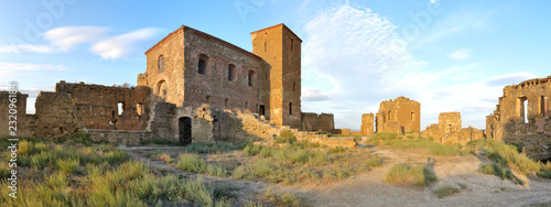 A landscape of the internal square of the abandoned Montearagon castle in the Aragon region, Spain, with a deep blue sky during a summer day photo