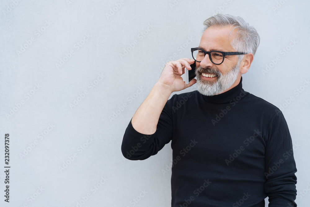 Attractive bearded man chatting on a mobile phone