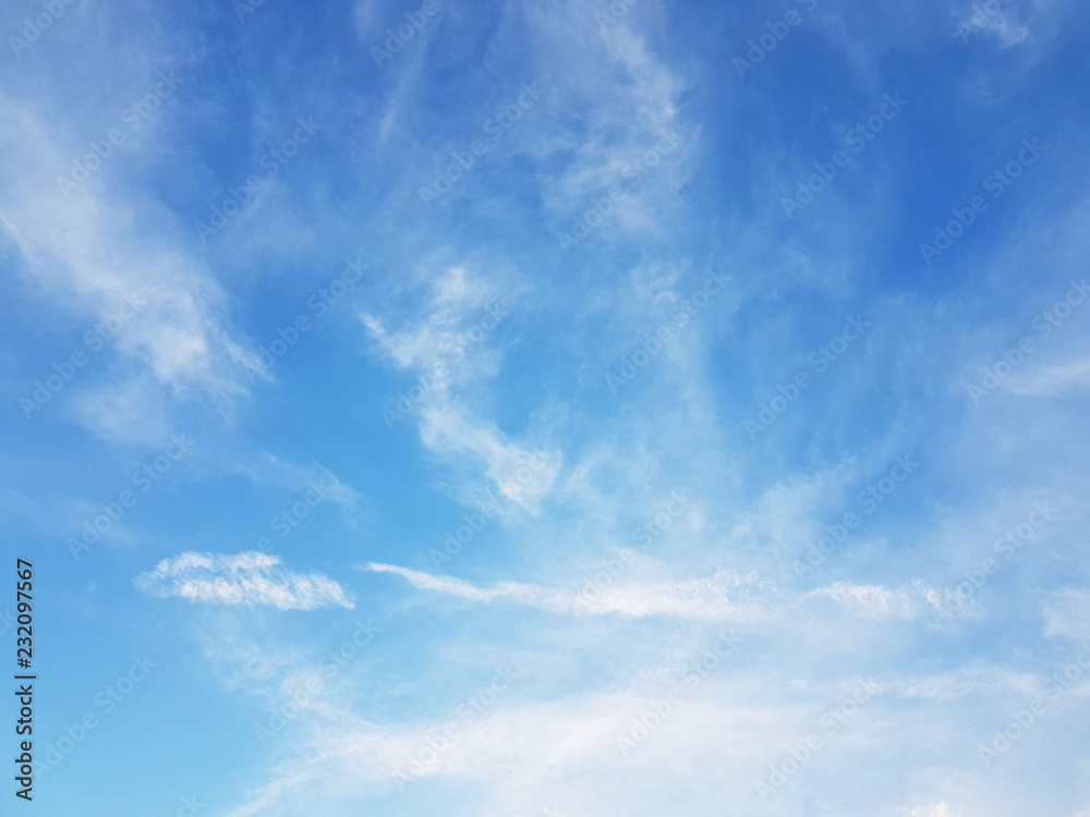 Blue sky with white cirrus clouds on a sunny clear day. Natural background for later design. Weather forecasting for water circulation in the atmosphere. Heaven is a symbol of holiness