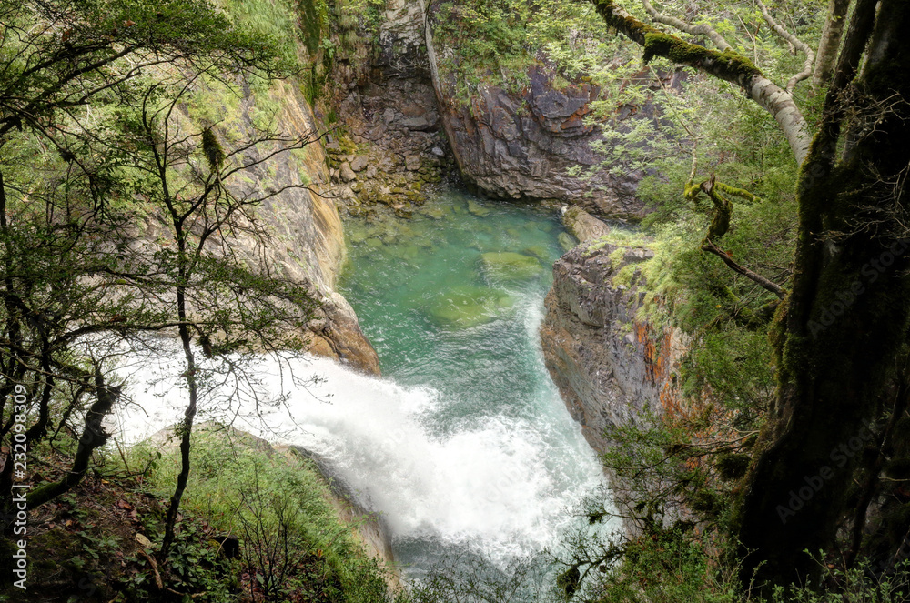 The waterfalls and the rapids in the Rio Bellos canyon on the forest covered rocky mountains in the Cañon de Añisclo valley, in Aragon region, Spain