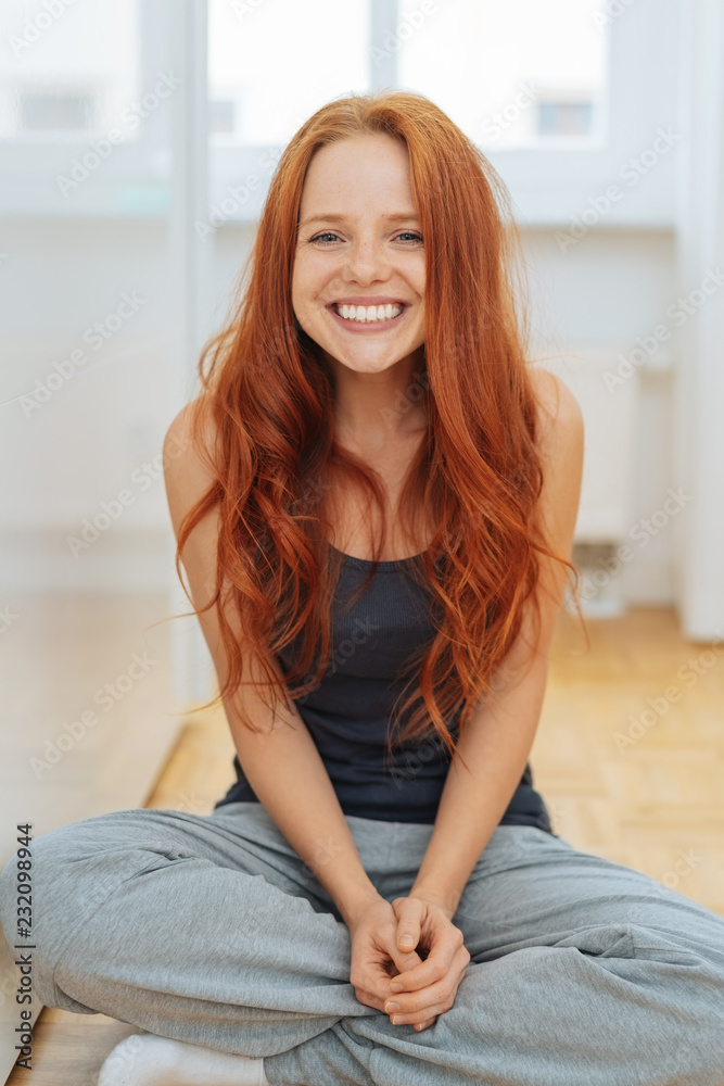 Happy red-haired woman wearing casual clothes