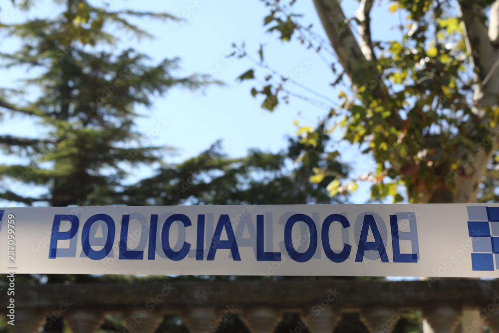 Obraz premium A Spanish police white and blue tape with the Local