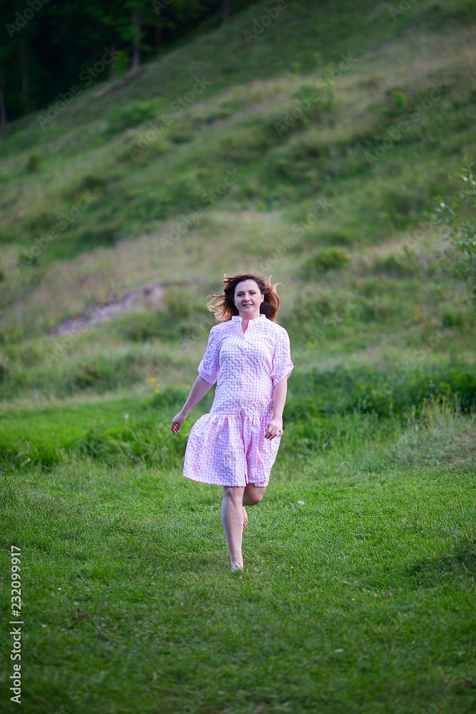 Beautiful girl in summer dress runs in the meadow. Beautiful girl in summer dress runs in the meadow.