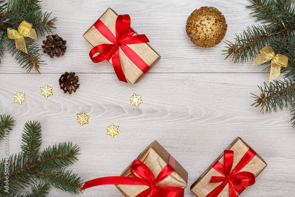 Gift boxes, fir tree branches with cones and christmas toys Gift boxes, fir tree branches with cones and christmas toys