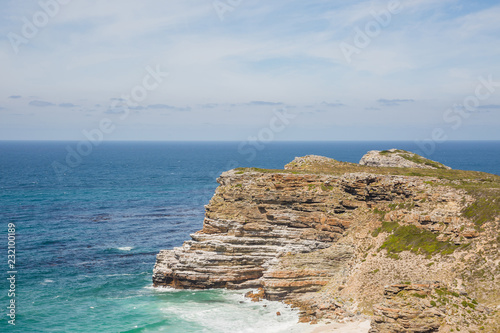 View of the ocean and a rockface in summer