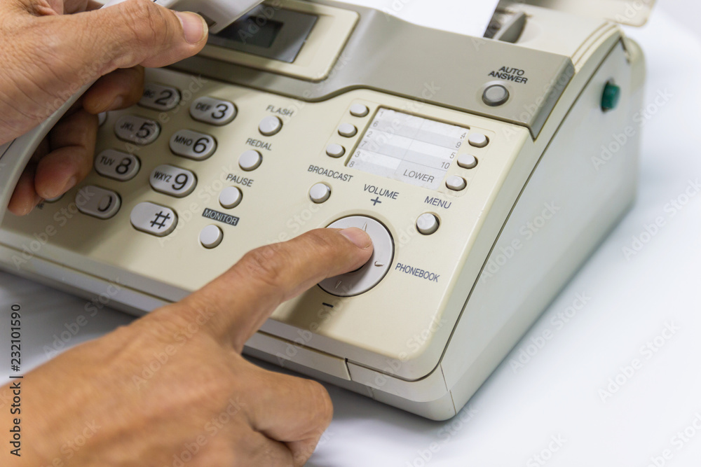 Hand man are using a fax machine in the office Business concept Hand man are using a fax machine in the office Business concept